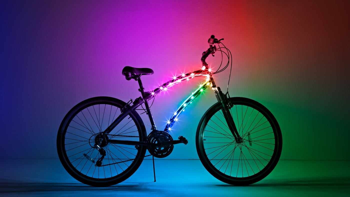 Bicycle with colorful LED lights against a gradient background