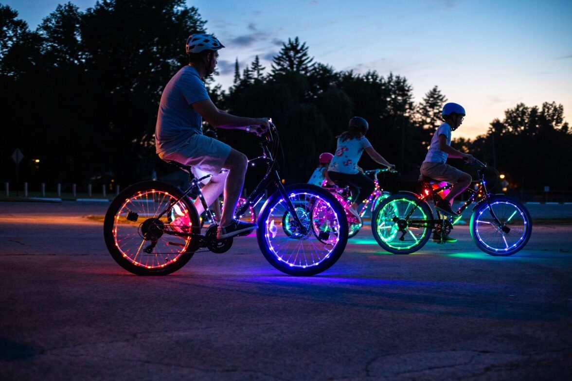 a family riding their bikes with LED lights on the wheels