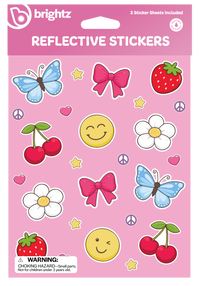 Brightz Reflective Stickers sheet featuring colorful cartoon stickers including blue butterflies, pink bows, red cherries, white flowers, yellow smiley faces, strawberries, peace signs, and stars on a pink background.