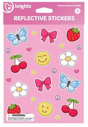 Brightz Reflective Stickers sheet featuring colorful cartoon stickers including blue butterflies, pink bows, red cherries, white flowers, yellow smiley faces, strawberries, peace signs, and stars on a pink background.