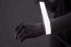Close-up of a person's arm with a white LED slap bracelet