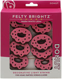 Packaged decorative light string with donut design on pink background